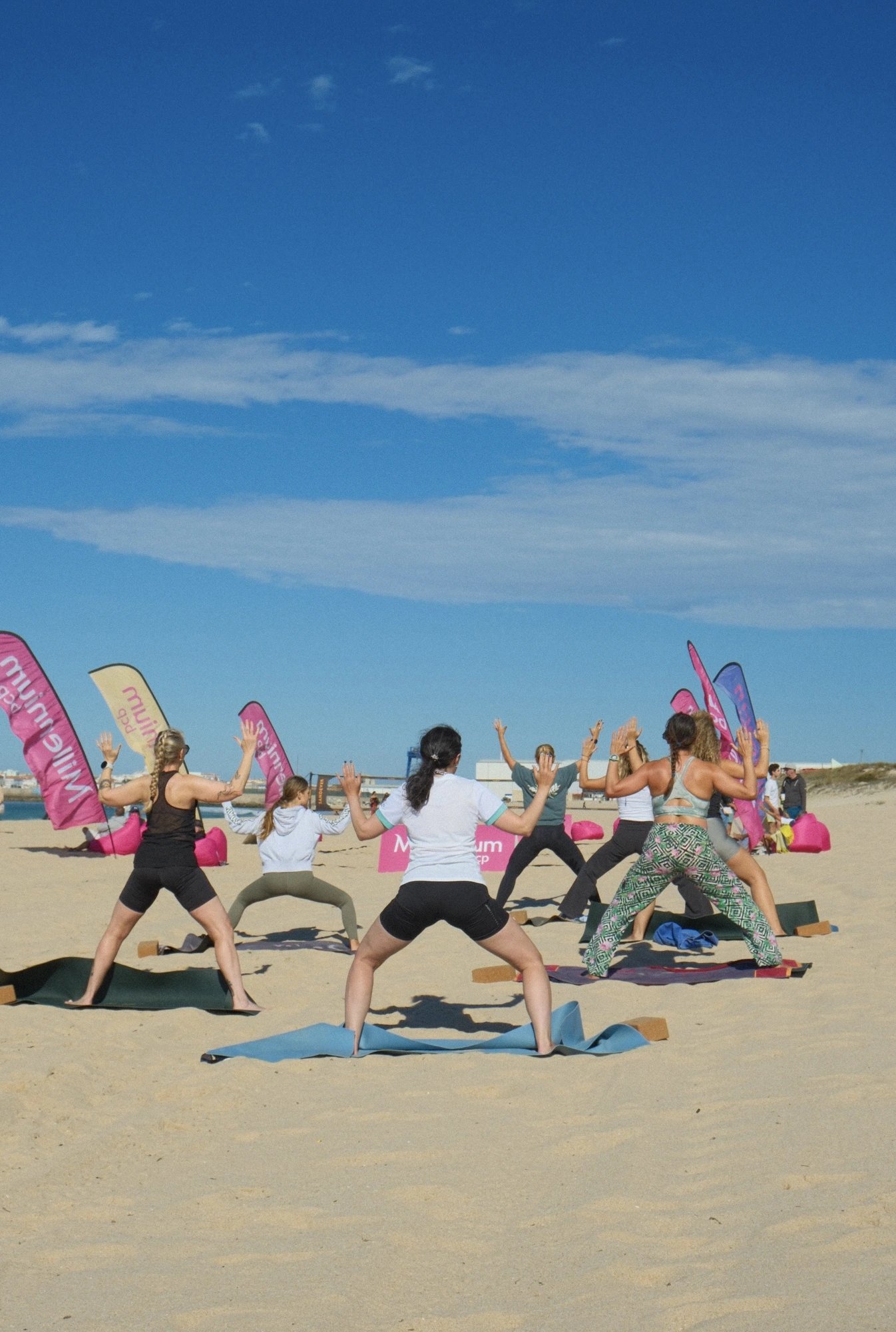 Beach yoga class in goddess pose at MEO Rip Curl Pro Portugal